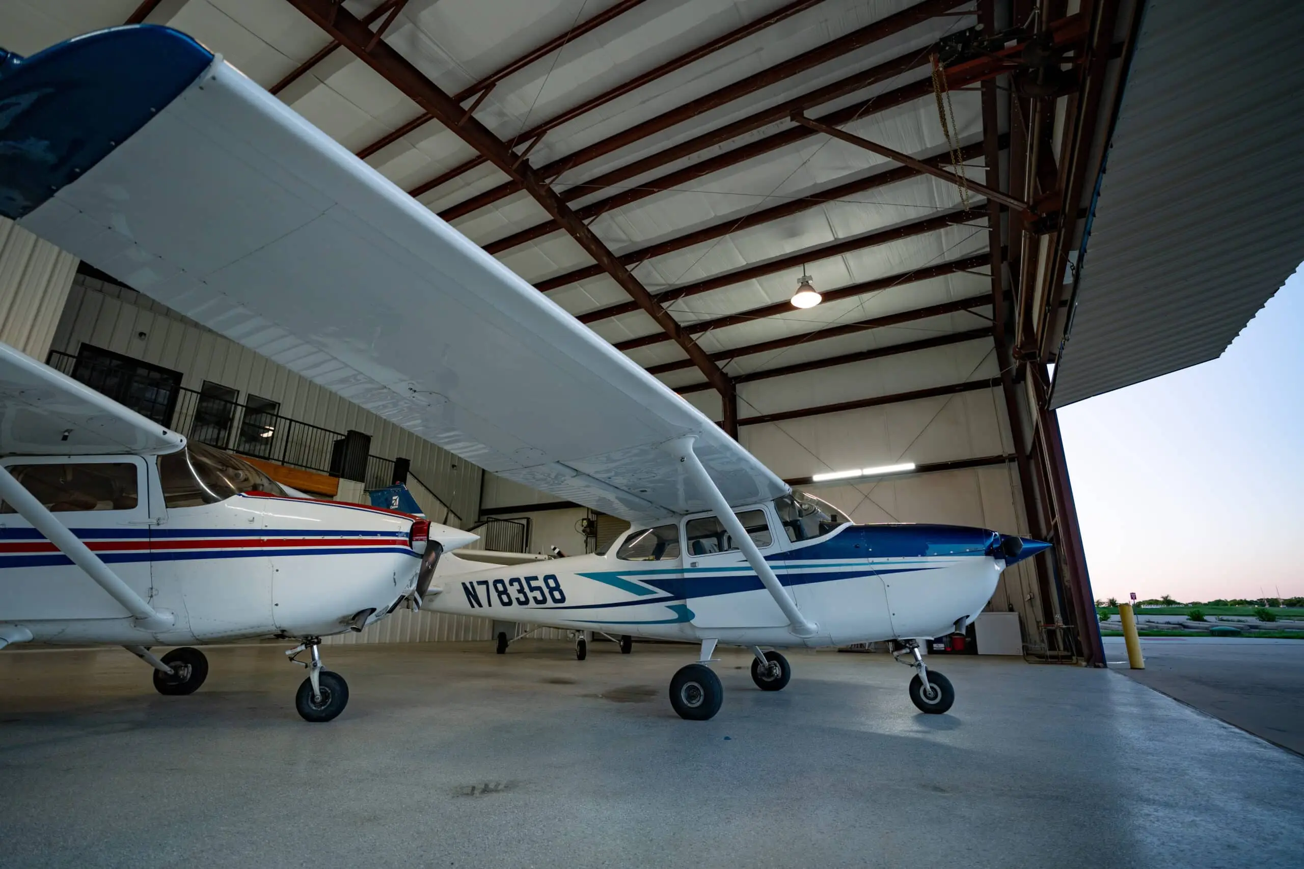 Red and white Cessna 172 parked on the ramp at Bird Dog Flight Services