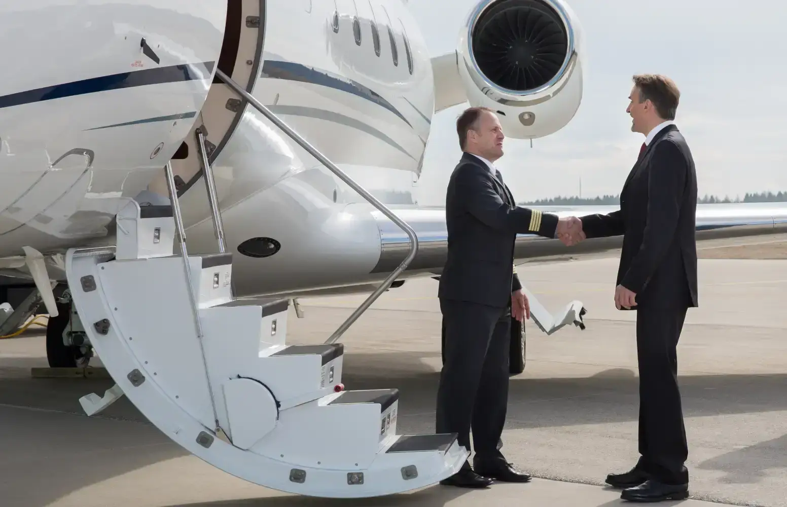 Commercial pilots standing next to a private airplane