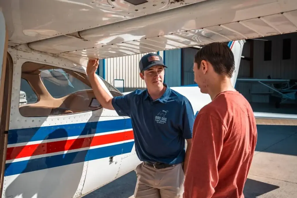 Flight instructor conducting a preflight inspection with a student pilot