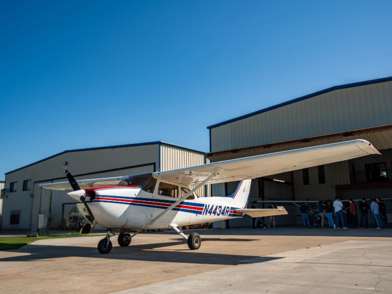 A Cessna 172M parked inside a hangar at a flight school in Fort Worth, Texas.