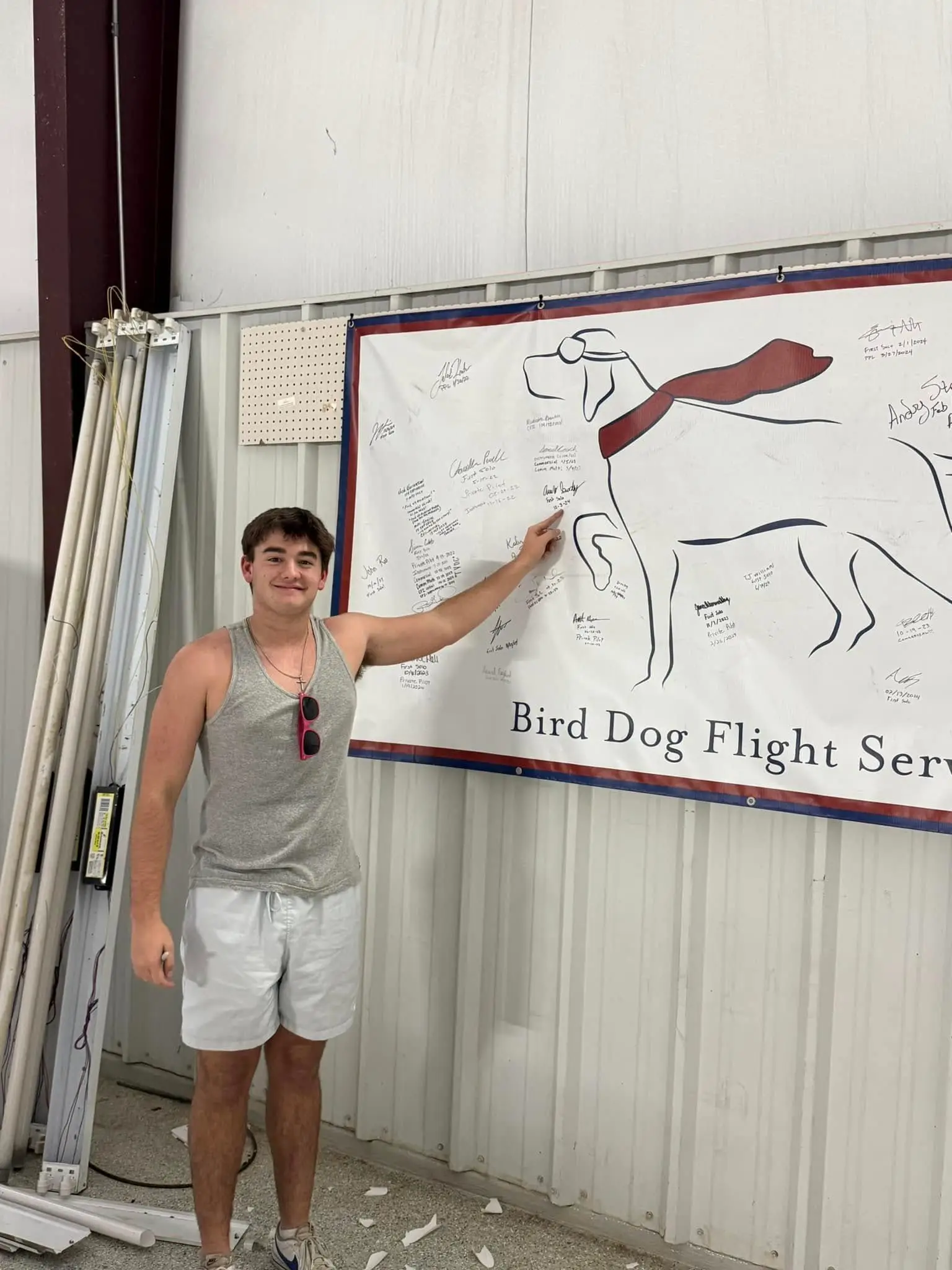 Student signing the wall at Bird Dog Aviation in Fort Worth