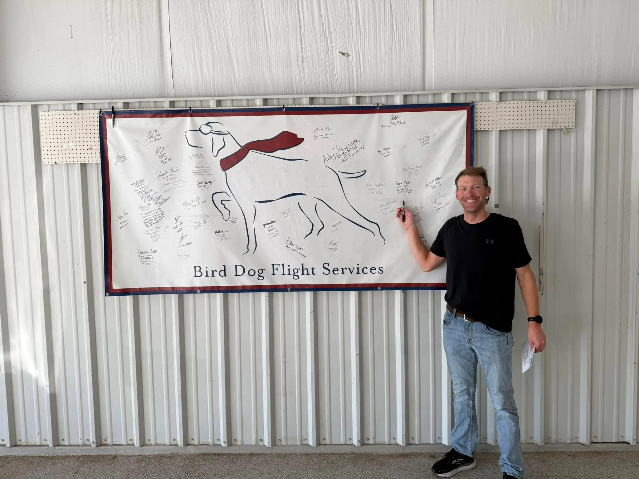 Student signing the wall at Bird Dog Flight Services after a checkride